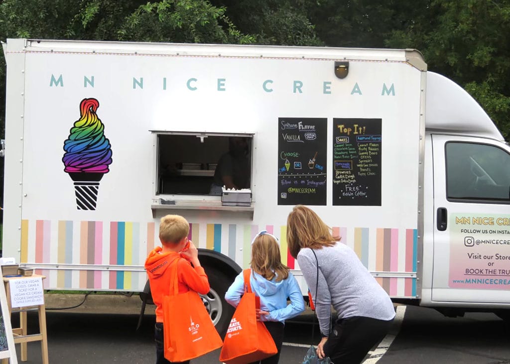 MN Nice Cream food truck shown here with a family standing in front of the food truck
